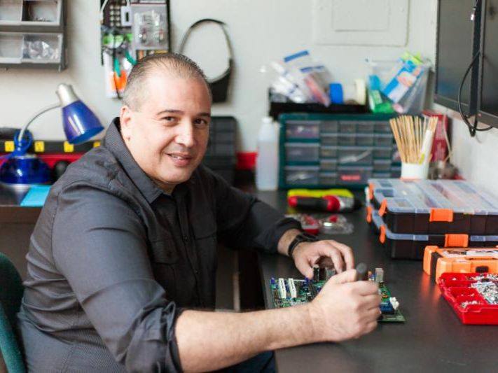 Northeast Computer Tech technician working on a computer board